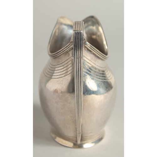 1882 - A GEORGE III SILVER CREAM JUG with reeded edge and engraved crest. London 1801 maker A & G  BURROWS.... 