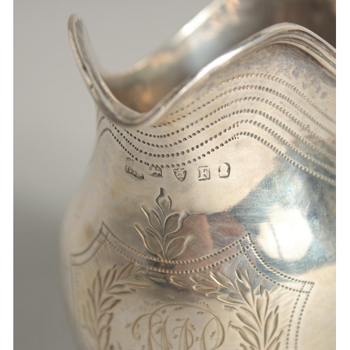 1882 - A GEORGE III SILVER CREAM JUG with reeded edge and engraved crest. London 1801 maker A & G  BURROWS.... 