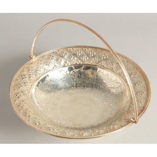 1889 - A VICTORIAN SILVER CIRCULAR BASKET with engraved and repousse decoration with headed edge and swing ... 