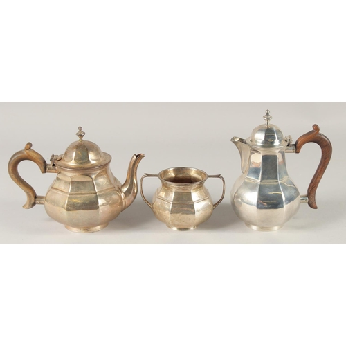 1890 - A THREE PIECE OCTAGONAL TEA SET, tea pot, hot water jug and sugar basin. Birmingham, mark rubbed, we... 