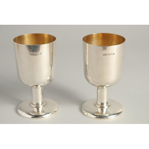 1892 - AN EXCELLENT PAIR OF SILVER GOBLETS BY R. J. J. with gilt interior.  Griffin crest. 4.75ins high, we... 