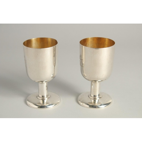 1892 - AN EXCELLENT PAIR OF SILVER GOBLETS BY R. J. J. with gilt interior.  Griffin crest. 4.75ins high, we... 