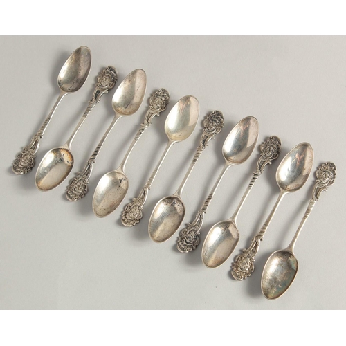 1895 - A SET OF TEN GEORGE II PICTURE BACK SILVER TEASPOONS with cast classical head finials.