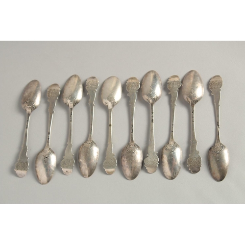 1895 - A SET OF TEN GEORGE II PICTURE BACK SILVER TEASPOONS with cast classical head finials.