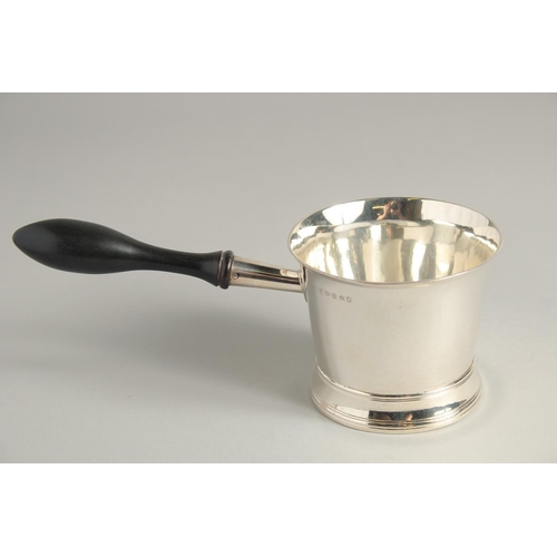 1898 - A GEORGE III SILVER BRANDY PAN with turned wood handle. 3.75ins diameter.  London 1804. Maker Peter ... 