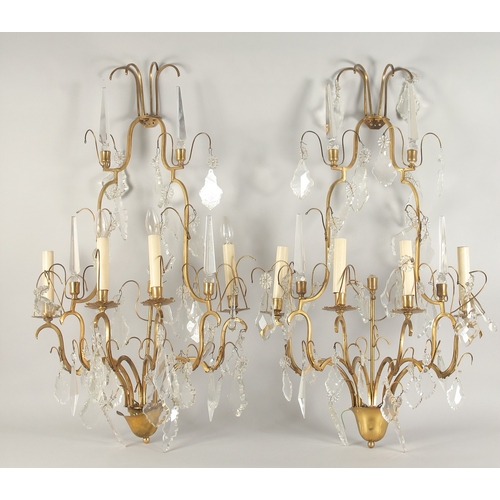 1467 - A PAIR OF ORNATE BRASS AND CUT GLASS WALL LIGHTS, of two tier form with four light fittings to each,... 