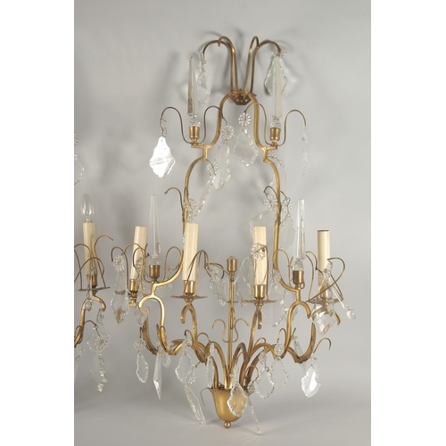 1467 - A PAIR OF ORNATE BRASS AND CUT GLASS WALL LIGHTS, of two tier form with four light fittings to each,... 