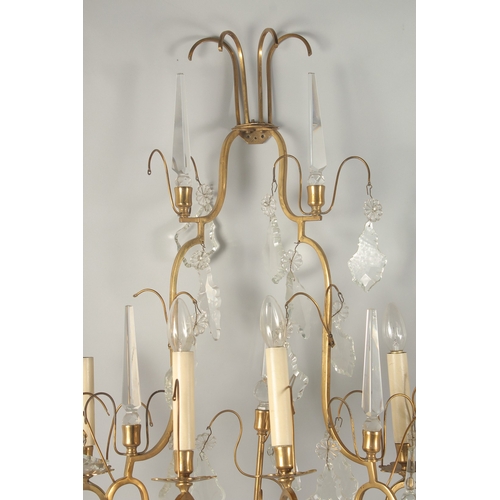 1467 - A PAIR OF ORNATE BRASS AND CUT GLASS WALL LIGHTS, of two tier form with four light fittings to each,... 