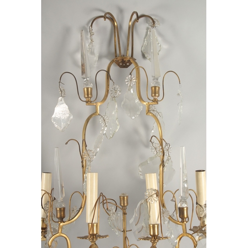 1467 - A PAIR OF ORNATE BRASS AND CUT GLASS WALL LIGHTS, of two tier form with four light fittings to each,... 