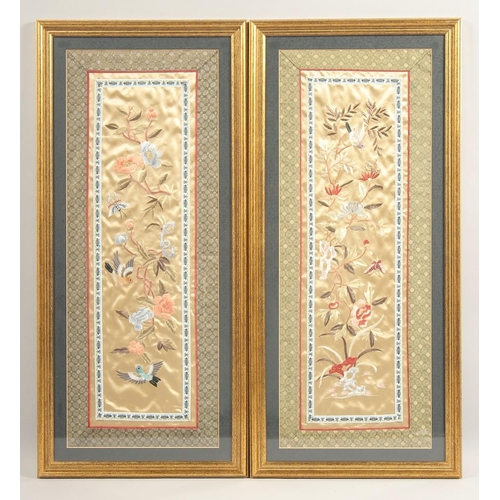 A PAIR OF 20TH CENTURY CHINESE EMBROIDERED SILK PANELS, with flora