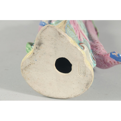 12 - A CHINESE FAMILLE ROSE PORCELAIN FIGURE, of a robed female holding flowers, 31cm high.