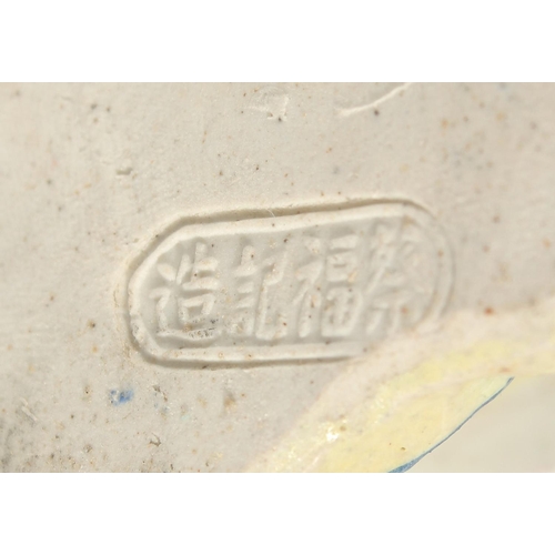 12 - A CHINESE FAMILLE ROSE PORCELAIN FIGURE, of a robed female holding flowers, 31cm high.