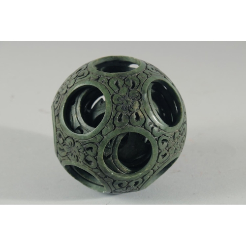 18 - A LARGE CHINESE CARVED HARDSTONE PUZZLE BALL, 12cm high, together with a carved jade figure of a gei... 