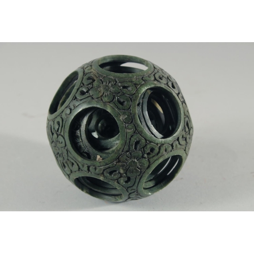 18 - A LARGE CHINESE CARVED HARDSTONE PUZZLE BALL, 12cm high, together with a carved jade figure of a gei... 