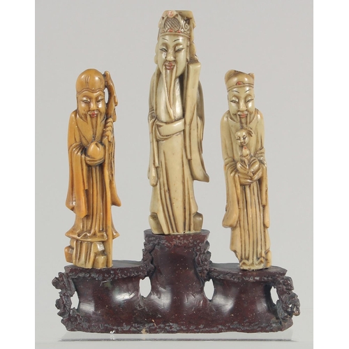 20 - TWO CHINESE SOAPSTONE CARVINGS, one carved with foo dogs, the other of immortals on a soapstone base... 