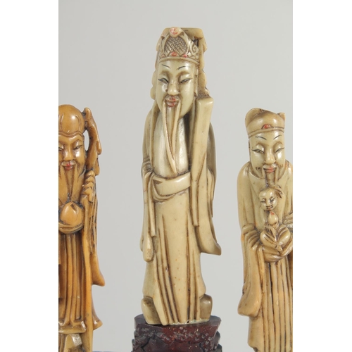 20 - TWO CHINESE SOAPSTONE CARVINGS, one carved with foo dogs, the other of immortals on a soapstone base... 