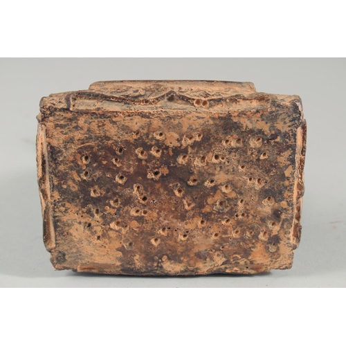 24 - A TIBETAN CARVED STONE SEATED FIGURE, with traces of gold paint, inscribed to the base, 18.5cm high.