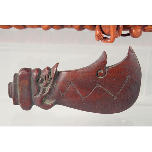 28 - THREE WOODEN CARVINGS, together with two walnut carvings, (5).