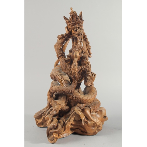 30 - A GOOD QUALITY LARGE THAI CARVED WOOD FIGURAL GROUP, 48cm high.