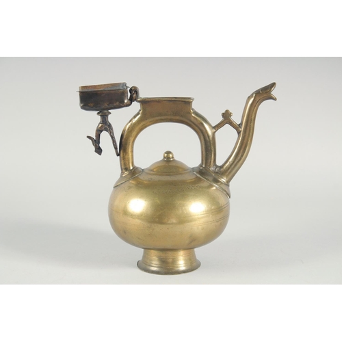39 - AN ISLAMIC BRONZE EWER, the handle with peacock finial, inscribed, 31cm high.