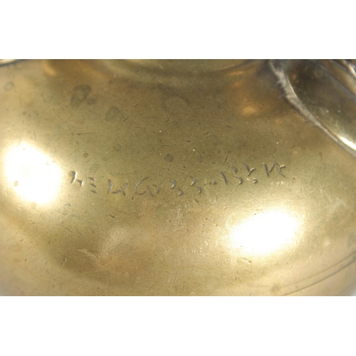 39 - AN ISLAMIC BRONZE EWER, the handle with peacock finial, inscribed, 31cm high.