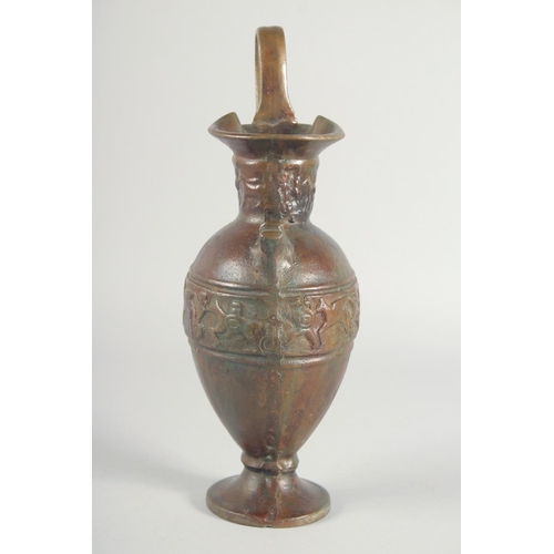 41 - AN EARLY CLASSICAL BRONZE EWER, with a band of archaic style figures to the body, 35cm high.