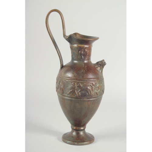 41 - AN EARLY CLASSICAL BRONZE EWER, with a band of archaic style figures to the body, 35cm high.
