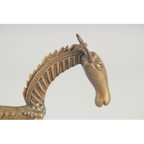 42 - AN ISLAMIC BRASS FIGURE OF A STYLISED HORSE, 24.5cm long.