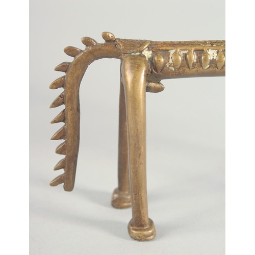 42 - AN ISLAMIC BRASS FIGURE OF A STYLISED HORSE, 24.5cm long.