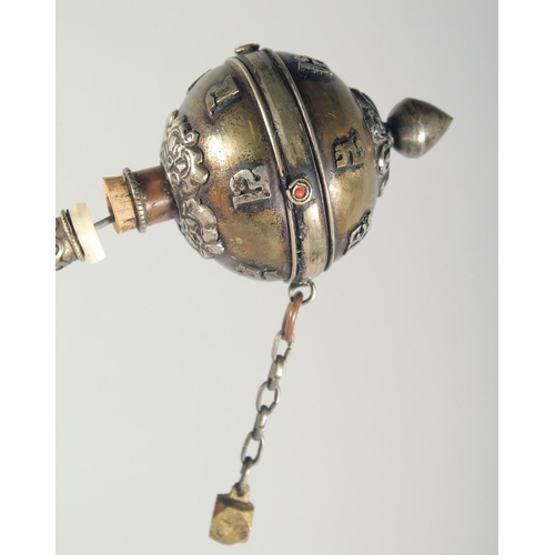 45 - A TIBETAN PRAYER WHEEL, with inscribed scroll inside, 21.5cm long.