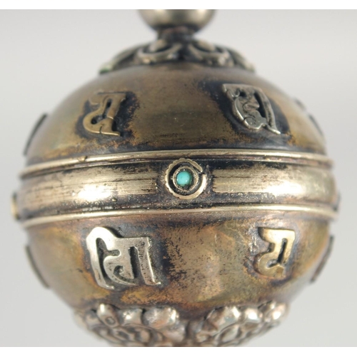 45 - A TIBETAN PRAYER WHEEL, with inscribed scroll inside, 21.5cm long.