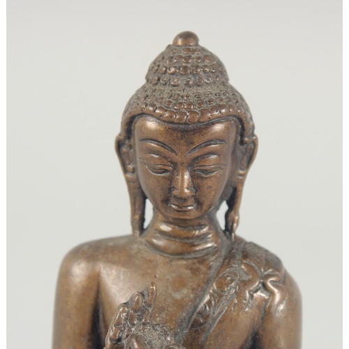 54 - A BRONZE FIGURE OF A SEATED BUDDHA, 14cm high.