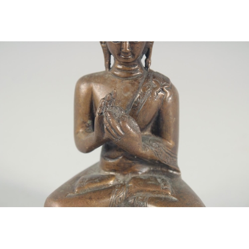 54 - A BRONZE FIGURE OF A SEATED BUDDHA, 14cm high.