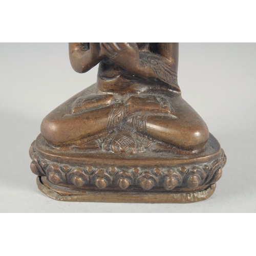 54 - A BRONZE FIGURE OF A SEATED BUDDHA, 14cm high.