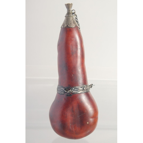 60 - A SMALL POWDER FLASK, with metal mounts, possibly a type of nut, 16cm long.
