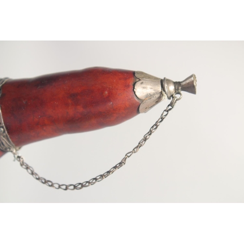 60 - A SMALL POWDER FLASK, with metal mounts, possibly a type of nut, 16cm long.