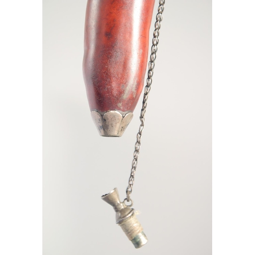 60 - A SMALL POWDER FLASK, with metal mounts, possibly a type of nut, 16cm long.