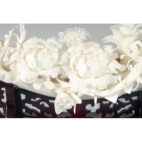 250 - A SUPERB CHINESE PORCELAIN FLORAL SCULPTURE elevated on a hardwood stand, contained within a glass d... 