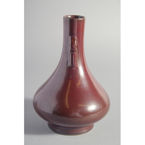 132 - A CHINESE OX BLOOD GLAZE TWIN HANDLE VASE, six-character mark to base, 22.5cm high.