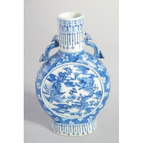 135 - A CHINESE BLUE AND WHITE PORCELAIN MOONFLASK, with moulded handles and painted with dragon and phoen... 