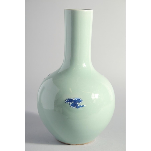 140 - A LARGE CHINESE CELADON GROUND BLUE AND WHITE PORCELAIN VASE, decorated with foo dogs, 34.5cm high.