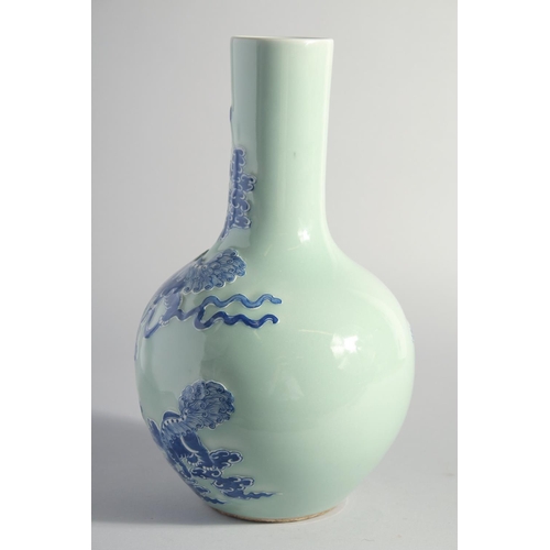 140 - A LARGE CHINESE CELADON GROUND BLUE AND WHITE PORCELAIN VASE, decorated with foo dogs, 34.5cm high.