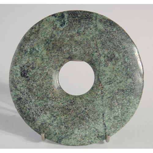 143 - A SMALL HARDSTONE BI DISK, 12.5cm diameter.