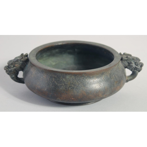 146 - A CHINESE BRONZE TWIN HANDLE CENSER, the handles formed as dragon heads, character mark to base, 18c... 