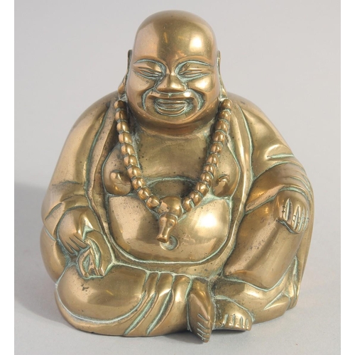 149 - A CHINESE BRASS BUDDHA on a fitted carved and pierced hardwood base.