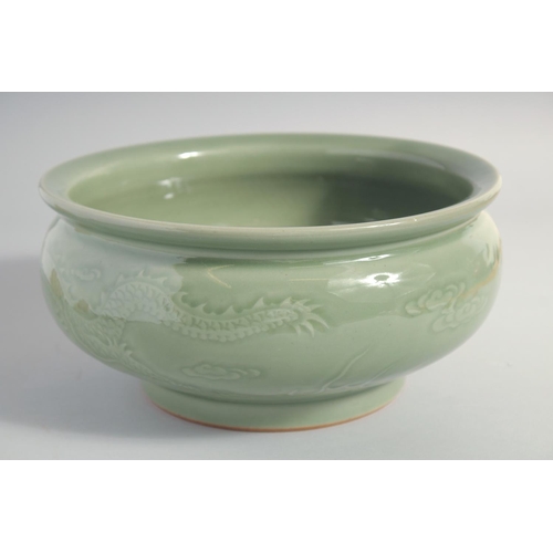 153 - A LARGE CHINESE CELADON GLAZE BOWL, carved with dragon and the flaming pearl of wisdom, 25.5cm diame... 