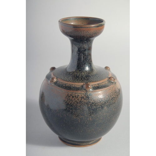 156 - A CHINESE TANG STYLE BLACK GLAZE VASE, 18cm high.