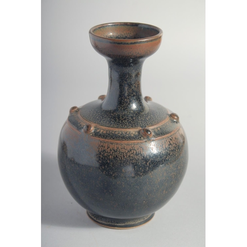 156 - A CHINESE TANG STYLE BLACK GLAZE VASE, 18cm high.