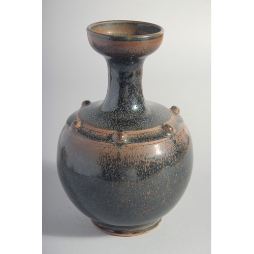 156 - A CHINESE TANG STYLE BLACK GLAZE VASE, 18cm high.