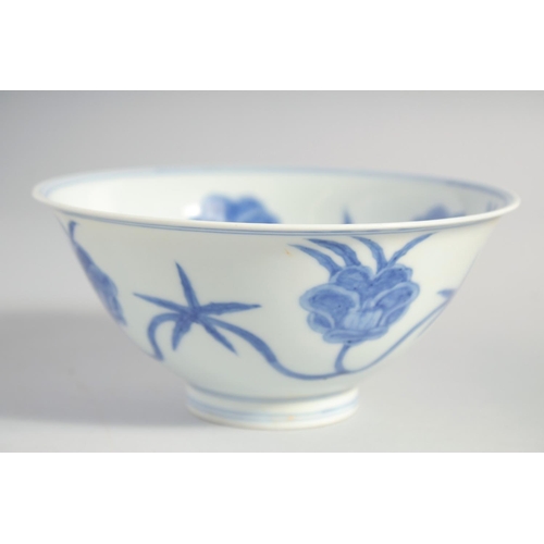 157 - A CHINESE BLUE AND WHITE MING STYLE BOWL, the interior and exterior painted with flower heads, base ... 